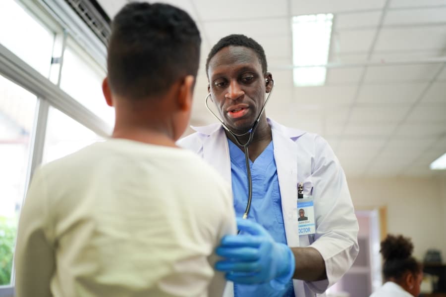 An RSPHCMB doctor examining a child