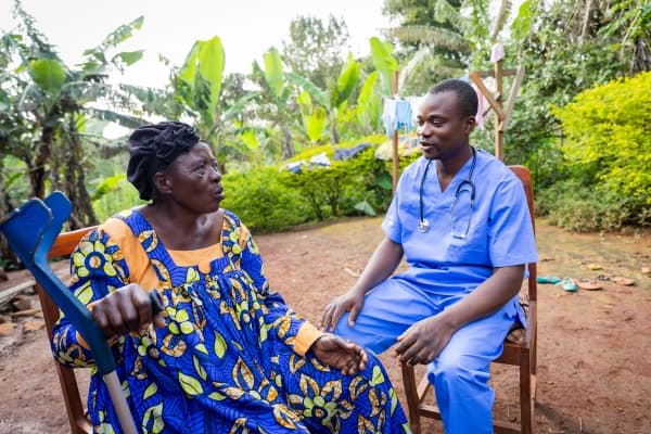A community health worker speaking with a resident